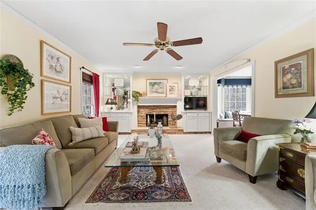 a living room with furniture fireplace and window
