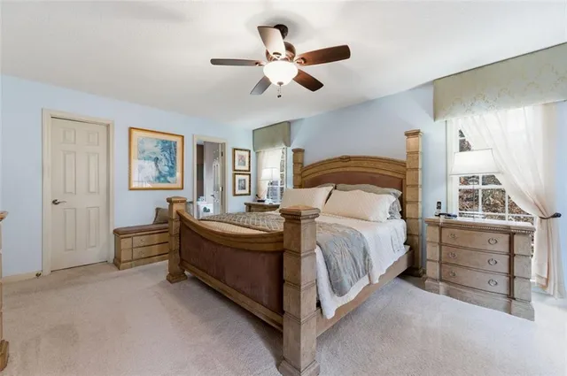 a spacious bedroom with a bed and a chandelier