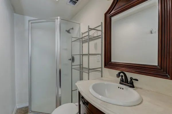 a bathroom with a sink toilet and shower