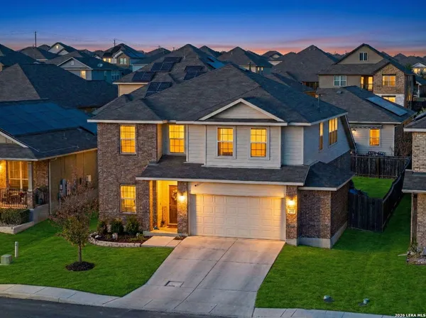 a front view of house with yard and green space