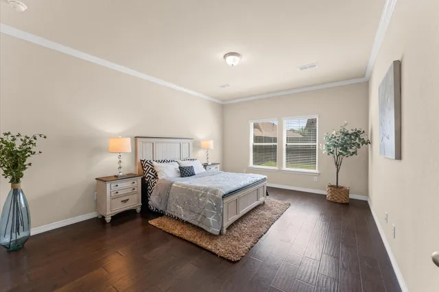 a spacious bedroom with a bed and a window