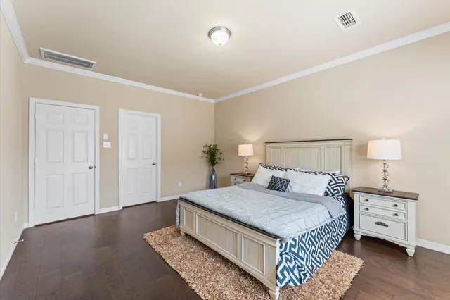 a bedroom with a bed and a night stand