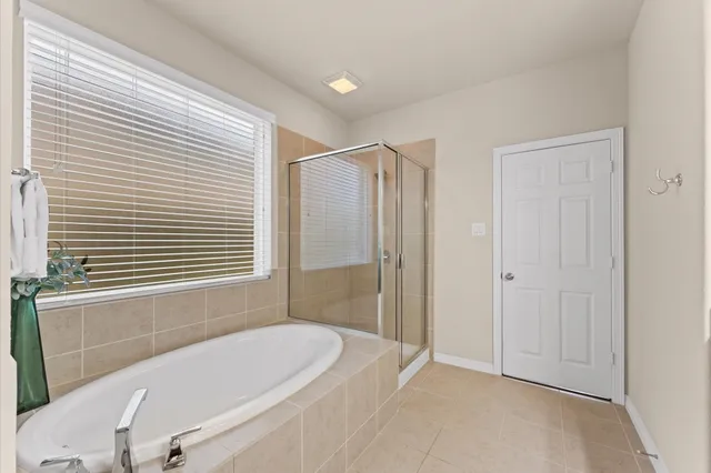 a bathroom with a bathtub and shower