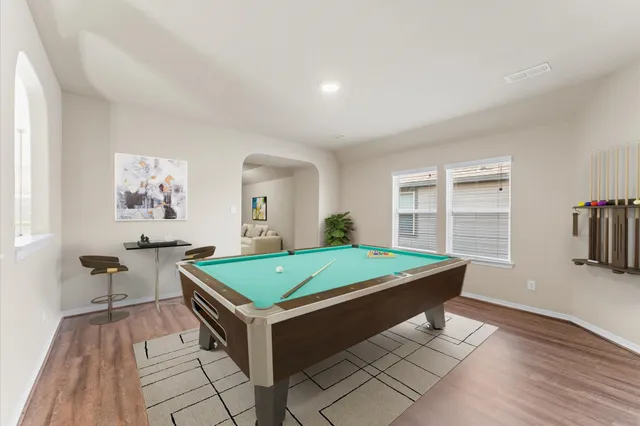 a room with pool table and window