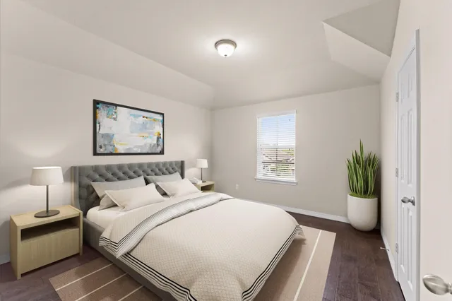 a bedroom with a bed and a potted plant