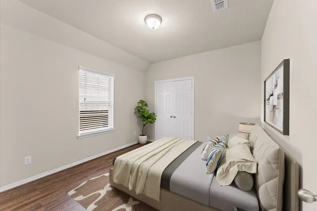 a bedroom with a large bed and a couch