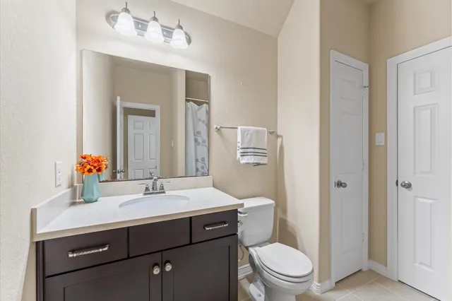 a bathroom with a sink toilet and mirror