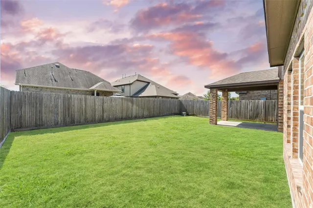 a view of a house with backyard and a garden