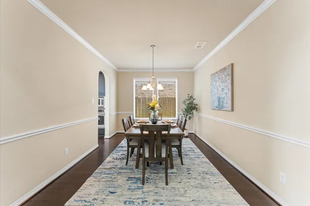 a dining room with furniture window and wooden floor