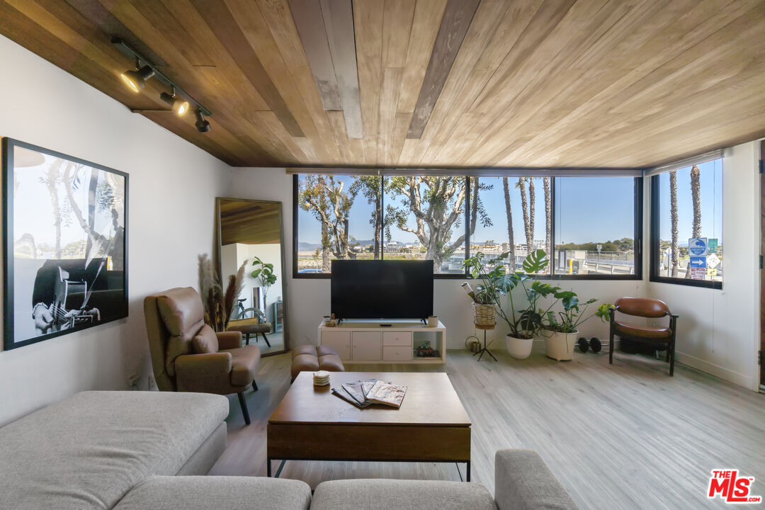 6209 Pacific Avenue, Unit 103 Playa del Rey, CA 90293 - Photo 36 of 40 a living room with furniture flat screen tv and a large window