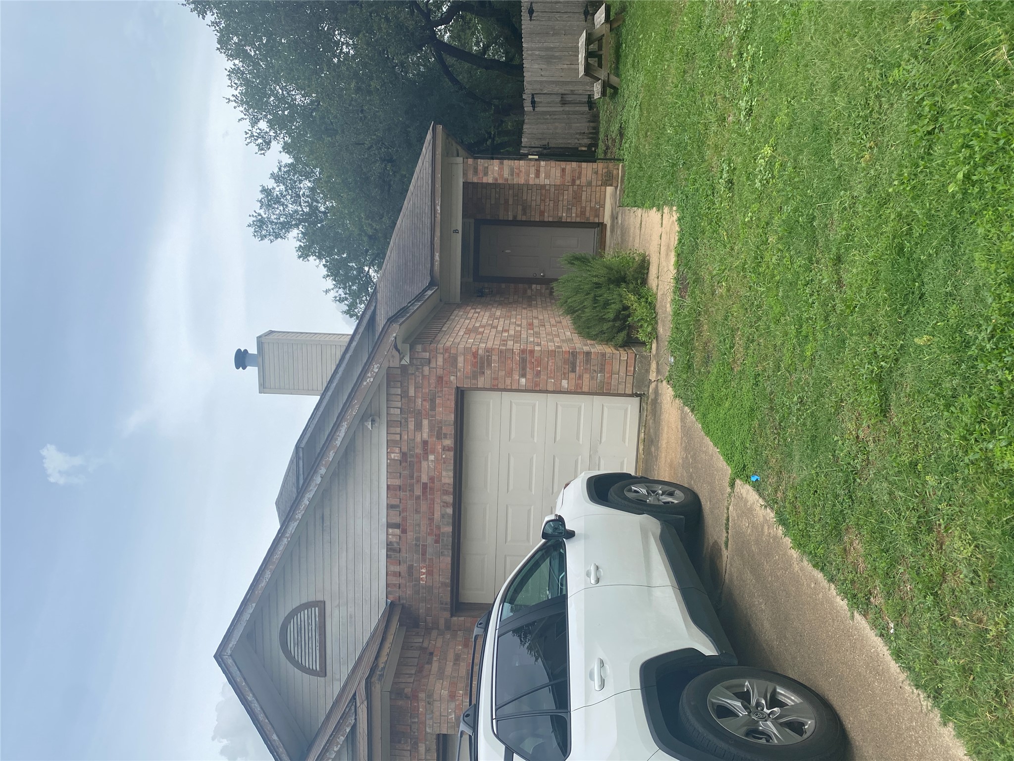2605 Alcott Lane, Unit B Austin, TX 78748 - Photo 14 of 15 Brick facade home featuring a convenient attached garage and ample front yard space.