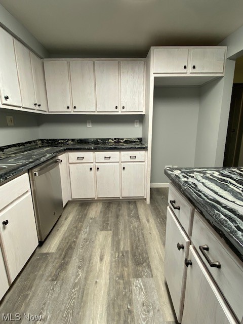 2216 Pressler Road Akron, OH 44312 - Photo 5 of 29 Kitchen featuring white cabinets, light hardwood / wood-style flooring, dark stone countertops, and dishwasher