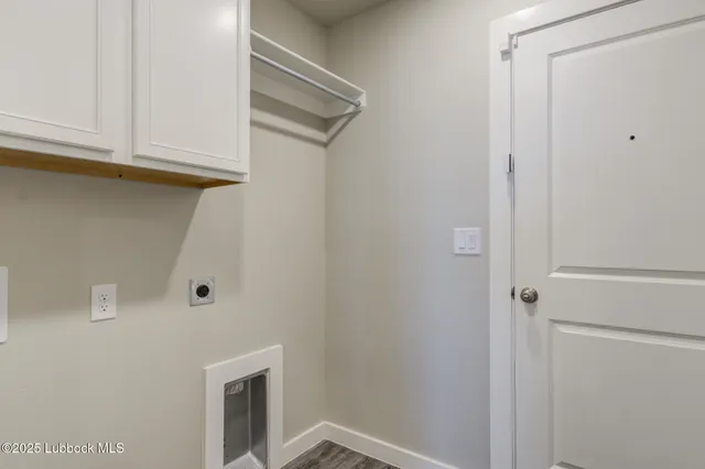 an empty room with a window and a chandelier fan