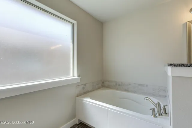 a bathroom with a shower and a sink
