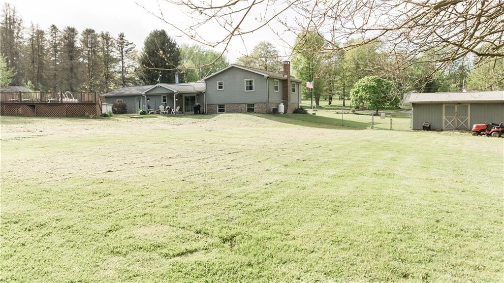 517 Unionville Road Butler, PA 16001 - Photo 3 of 20 The view from the back of the property shows the covered back patio, the above ground pool with huge composite deck, the fenced in yard and the large shed