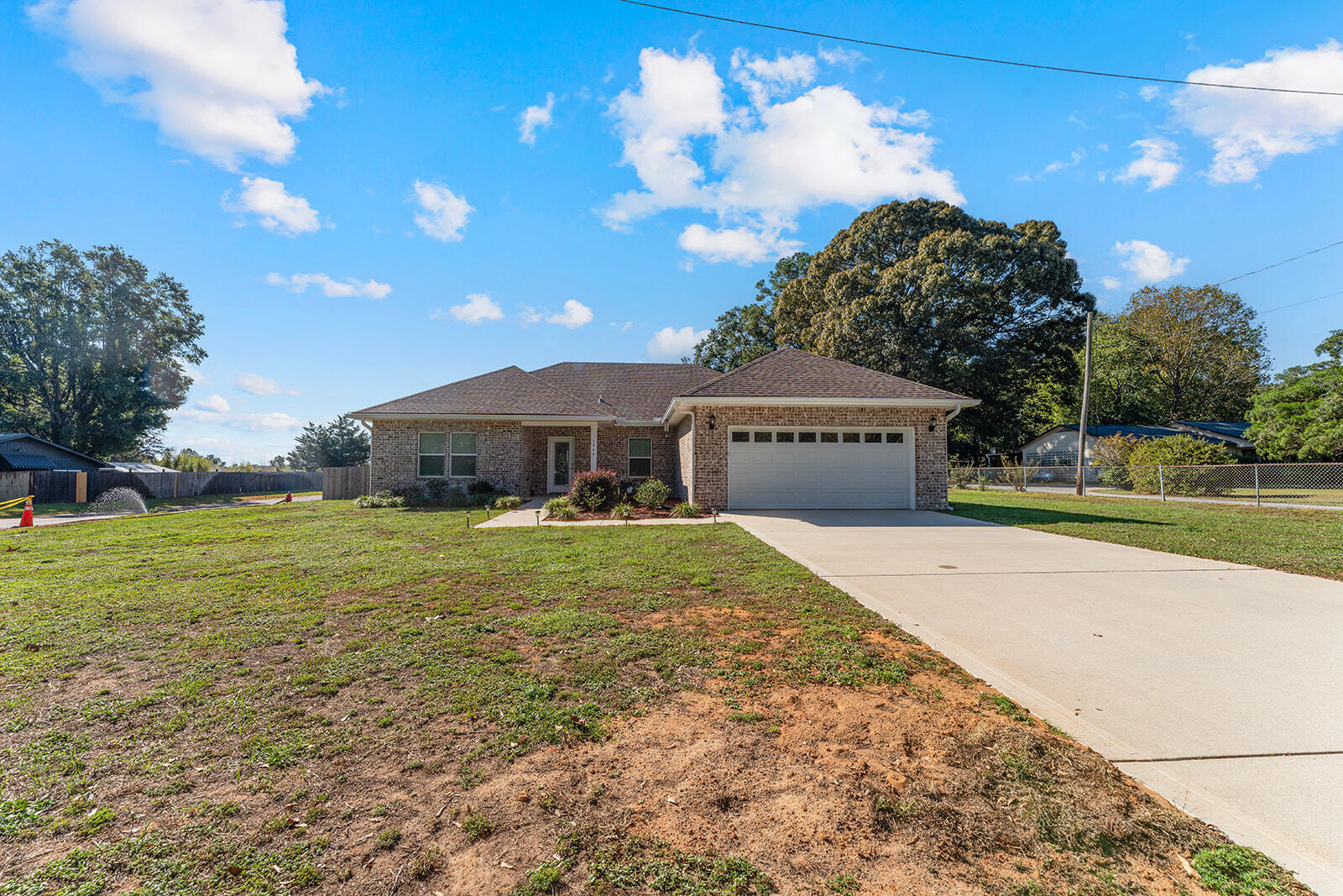 a front view of house with yard and trees