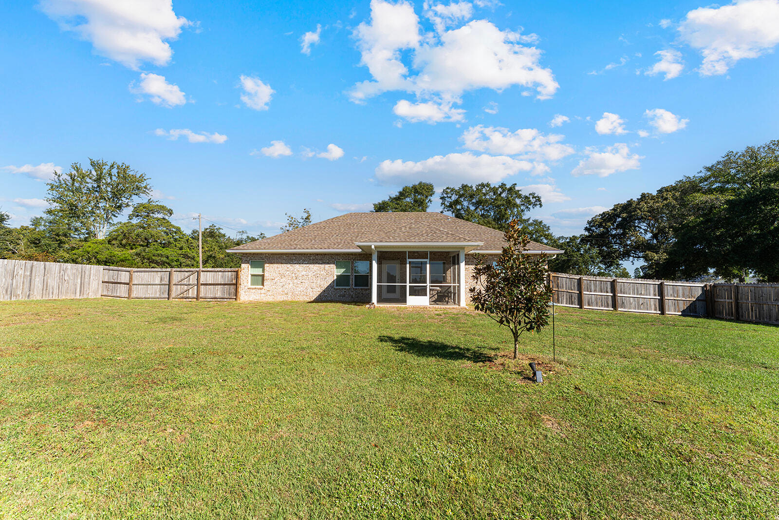2944 Barton Road Crestview, FL 32539 - Photo 38 of 42 a backyard of a house with table and chairs