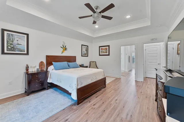 a spacious bedroom with a bed and a flat screen tv