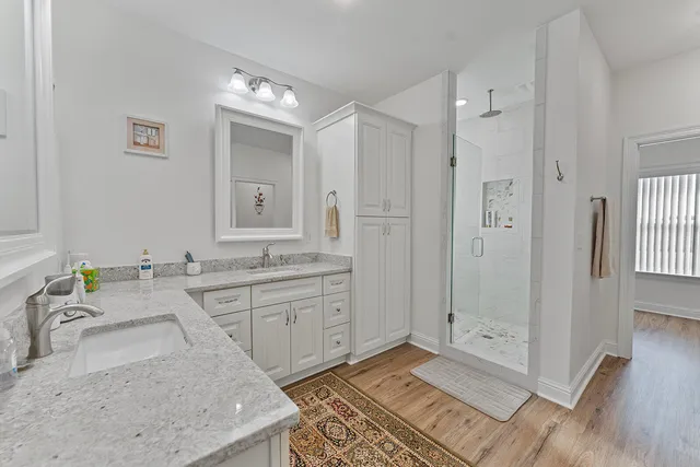 a spacious bathroom with a granite countertop sink and a mirror