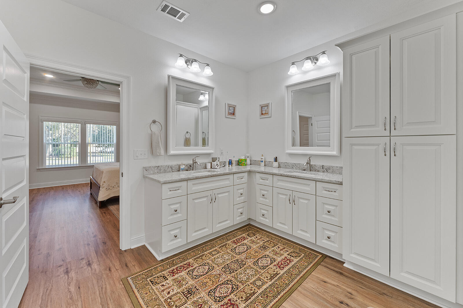 2944 Barton Road Crestview, FL 32539 - Photo 8 of 44 a spacious bathroom with a granite countertop sink a mirror and a toilet