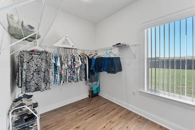 a view of a room with lots of stuff and hardwood floor