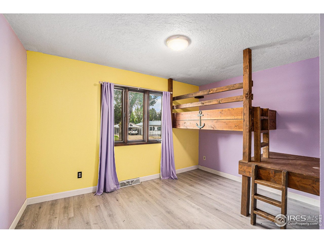 1240 3rd Street Eaton, CO 80615 - Photo 11 of 24 a view of an empty room with wooden floor and a window