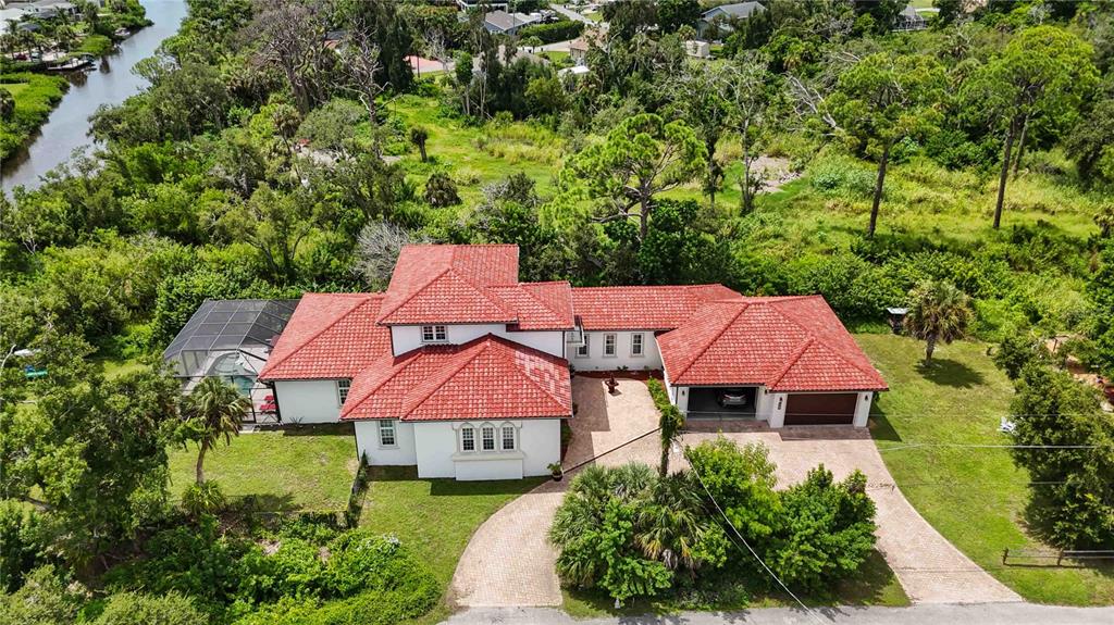 an aerial view of a house with swimming pool and garden