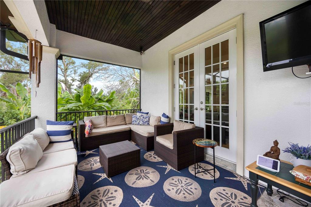 3674 Roslyn Road Venice, FL 34293 - Photo 13 of 72 a living room with furniture and a flat screen tv next to a large window