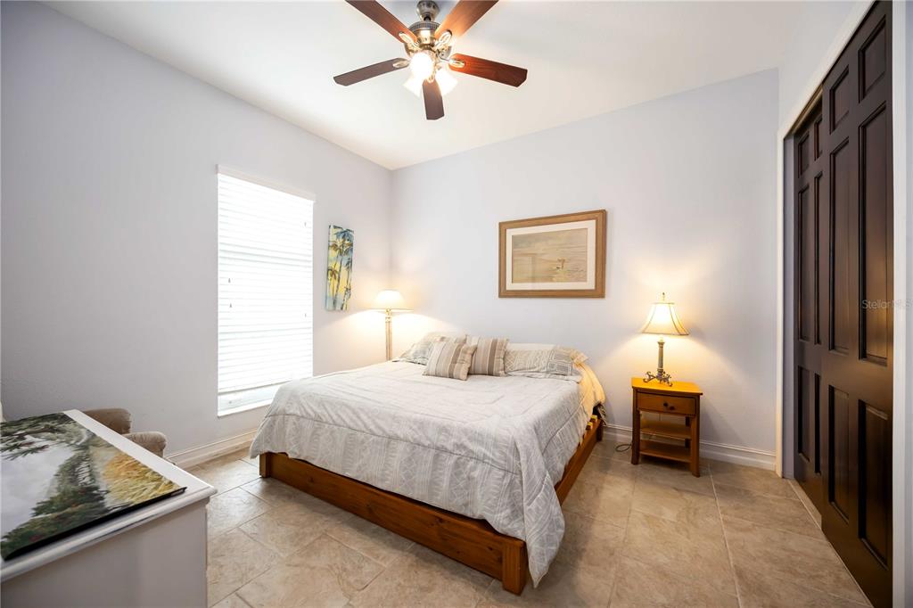 3674 Roslyn Road Venice, FL 34293 - Photo 21 of 72 a bedroom with a bed and a chandelier