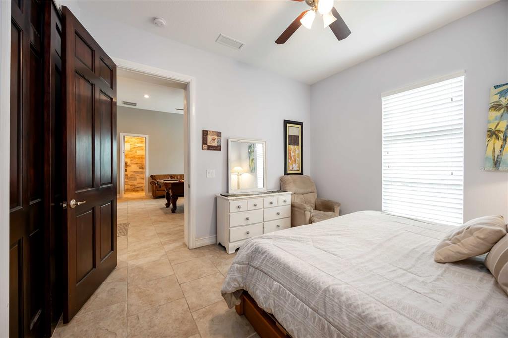 3674 Roslyn Road Venice, FL 34293 - Photo 22 of 72 a bedroom with a bed and a chandelier