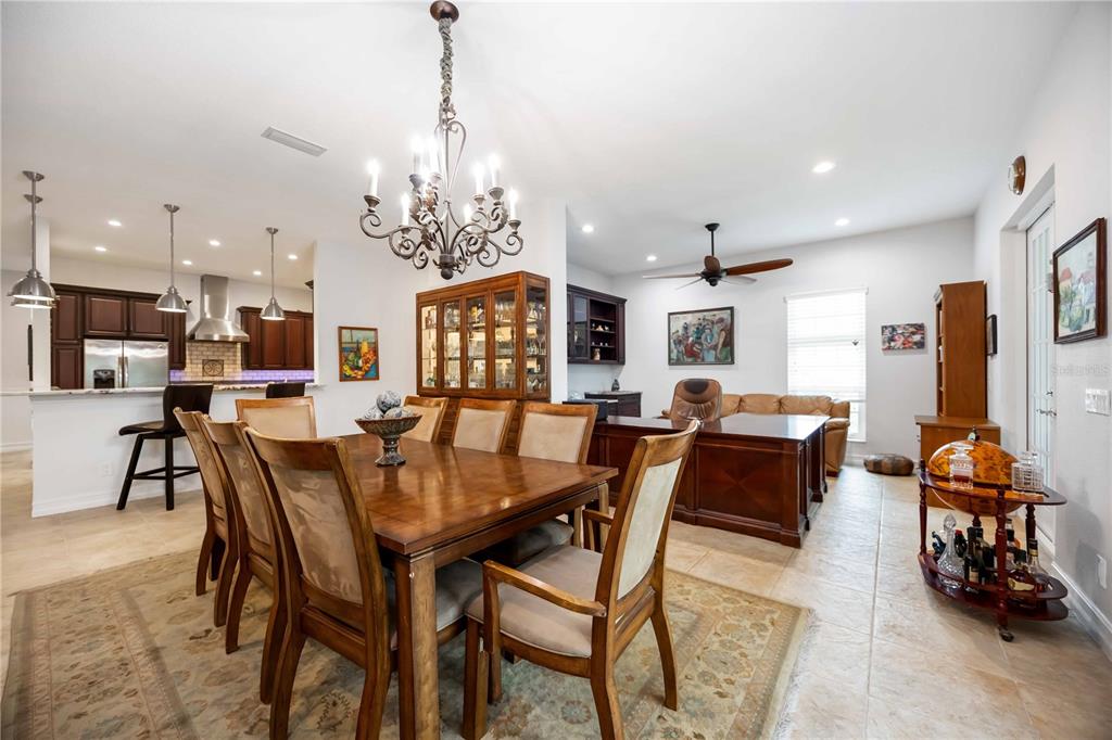3674 Roslyn Road Venice, FL 34293 - Photo 28 of 72 a view of a dining room with furniture and a chandelier