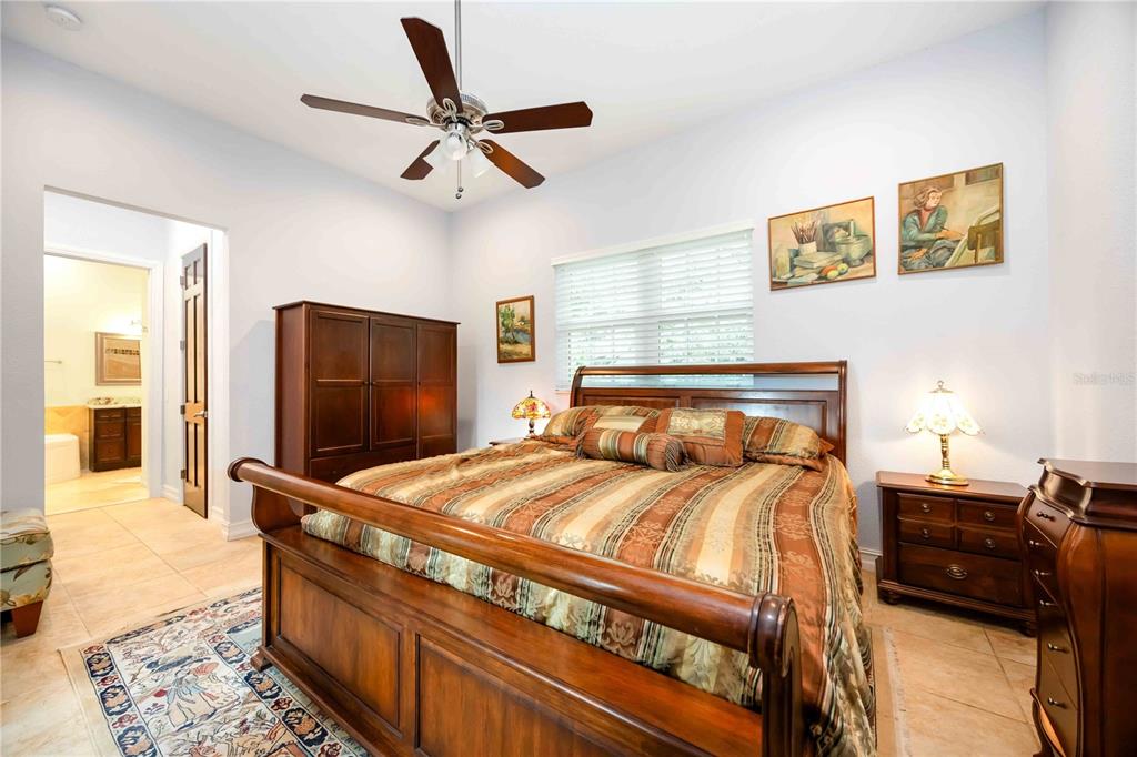 3674 Roslyn Road Venice, FL 34293 - Photo 35 of 72 a bedroom with a bed and a flat screen tv