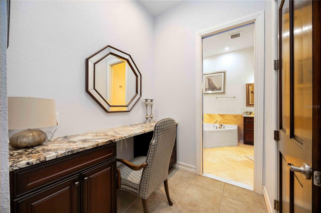 3674 Roslyn Road Venice, FL 34293 - Photo 36 of 72 a bathroom with a granite countertop sink a mirror and a bathtub