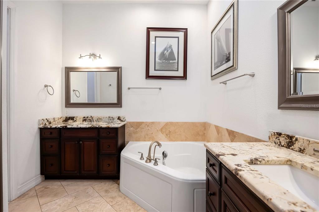 3674 Roslyn Road Venice, FL 34293 - Photo 37 of 72 a bathroom with a tub sink and mirror