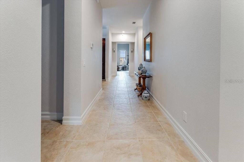 3674 Roslyn Road Venice, FL 34293 - Photo 39 of 72 a view of a hallway with a room and a mirror