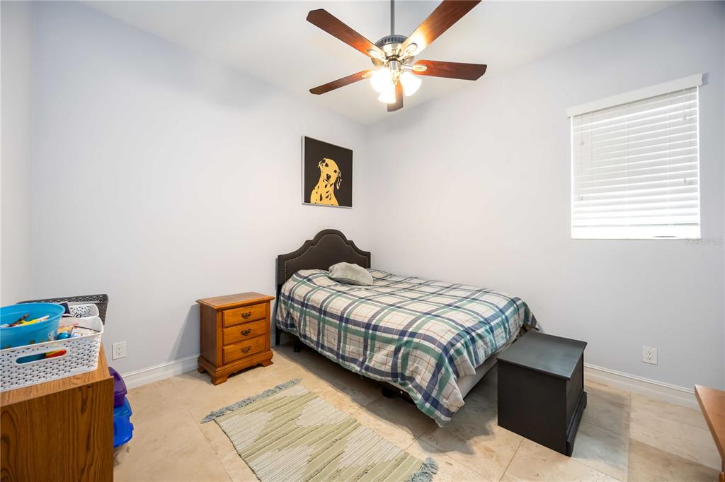 3674 Roslyn Road Venice, FL 34293 - Photo 43 of 72 a bedroom with a bed and a chandelier