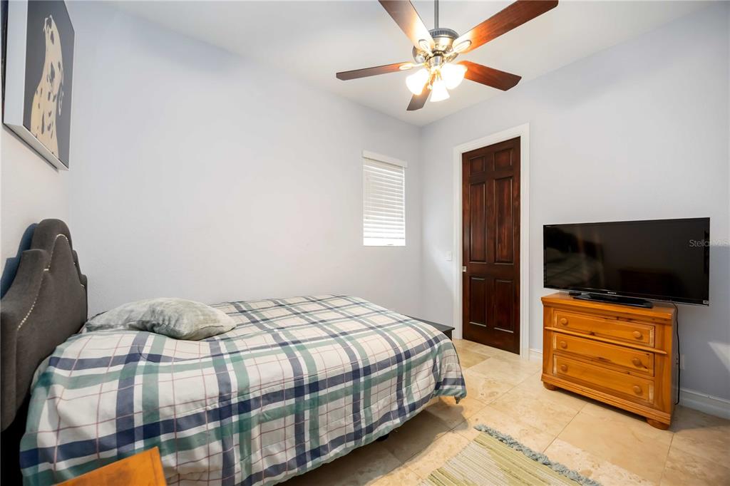 3674 Roslyn Road Venice, FL 34293 - Photo 44 of 72 a bedroom with a bed and a flat screen tv