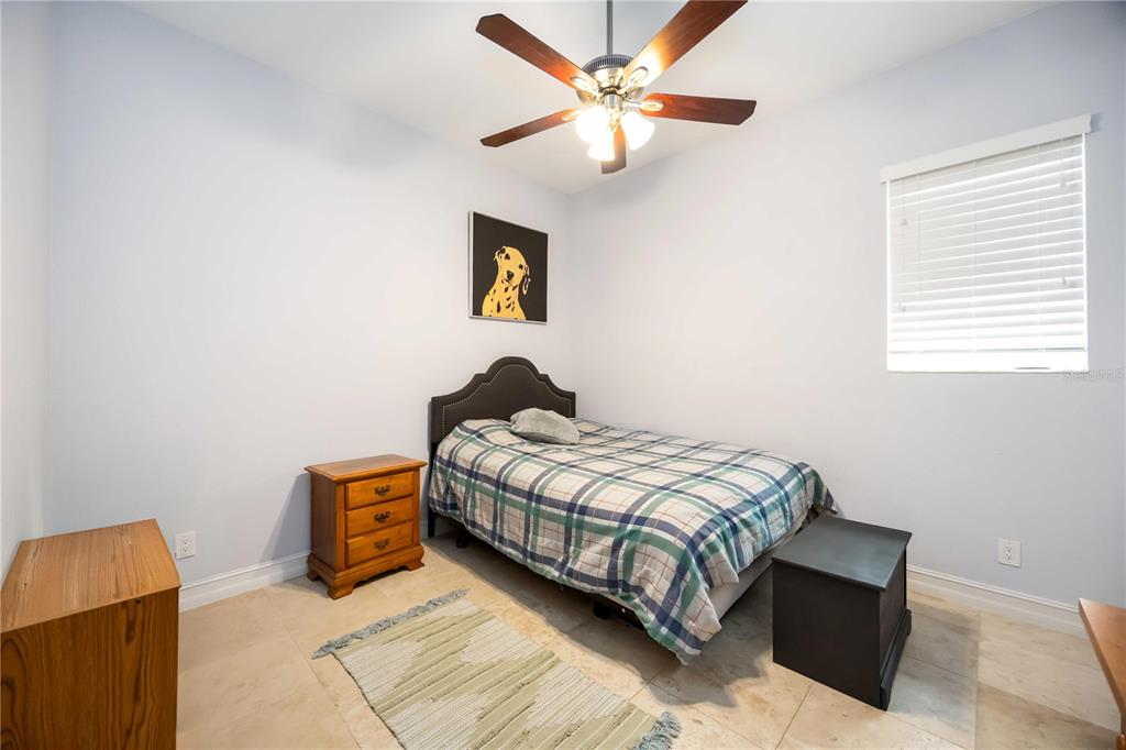 3674 Roslyn Road Venice, FL 34293 - Photo 45 of 72 a bedroom with a bed and a chandelier