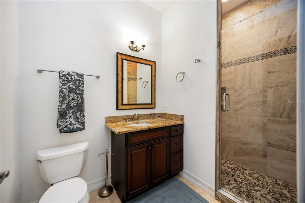 3674 Roslyn Road Venice, FL 34293 - Photo 51 of 72 a bathroom with a toilet a sink and mirror