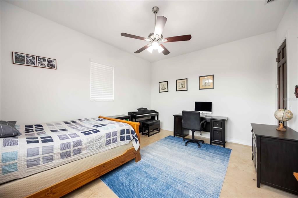 3674 Roslyn Road Venice, FL 34293 - Photo 53 of 72 a bedroom with a bed and a flat screen tv