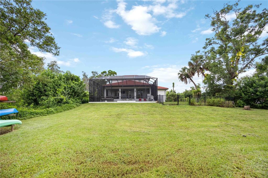 3674 Roslyn Road Venice, FL 34293 - Photo 60 of 72 a view of a big house with a big yard and large trees