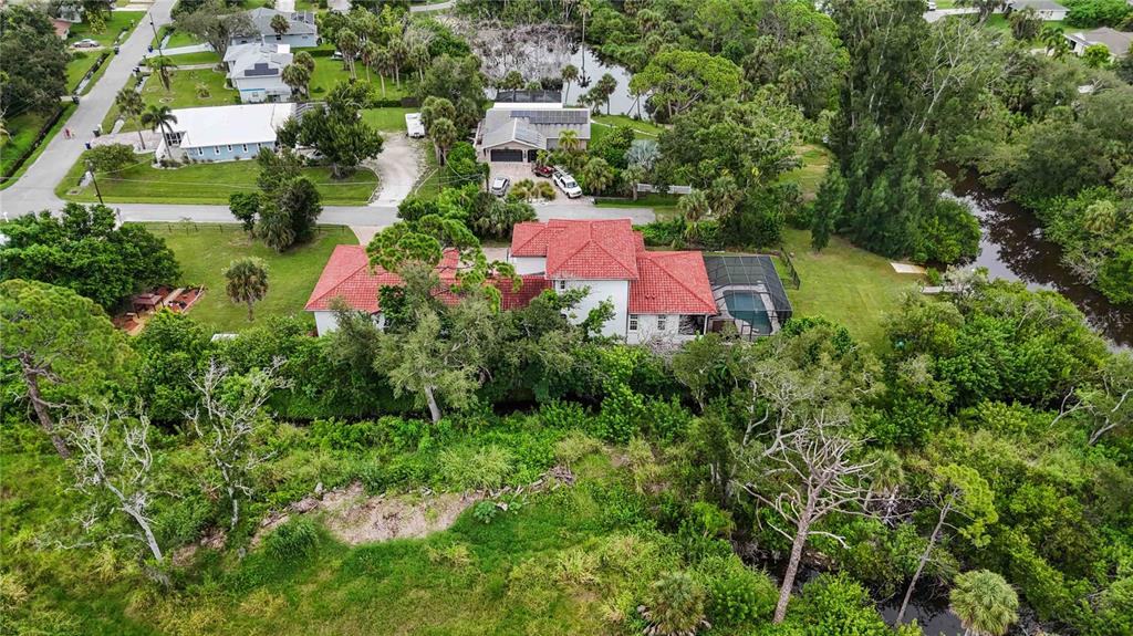 3674 Roslyn Road Venice, FL 34293 - Photo 65 of 72 an aerial view of a house with a yard and lake view