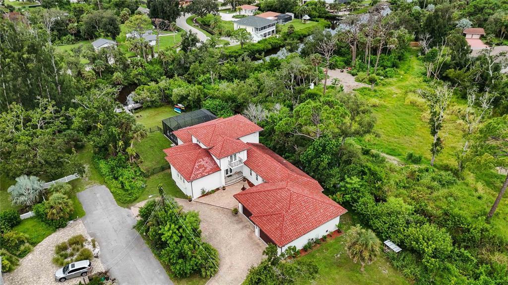 3674 Roslyn Road Venice, FL 34293 - Photo 70 of 72 an aerial view of a house with a yard