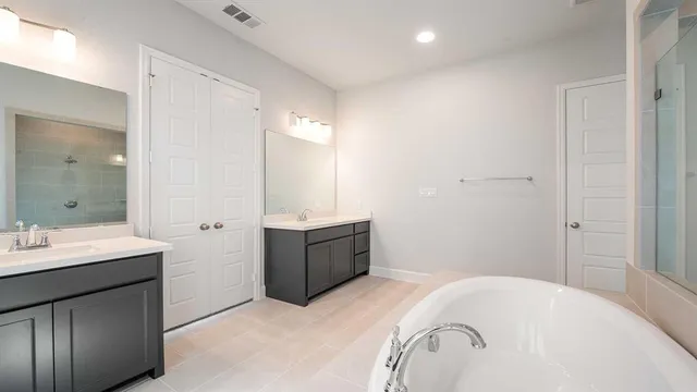 a bathroom with a bathtub sink and mirror