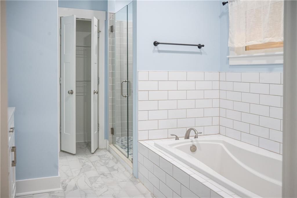 151 Cherokee Point Drive Canton, GA 30114 - Photo 125 of 163 a bathroom with a bathtub and a shower
