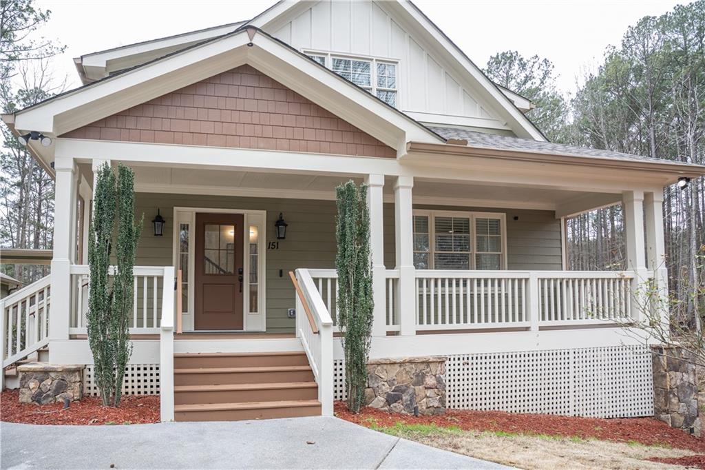 151 Cherokee Point Drive Canton, GA 30114 - Photo 16 of 163 a view of a house with a large window and wooden fence