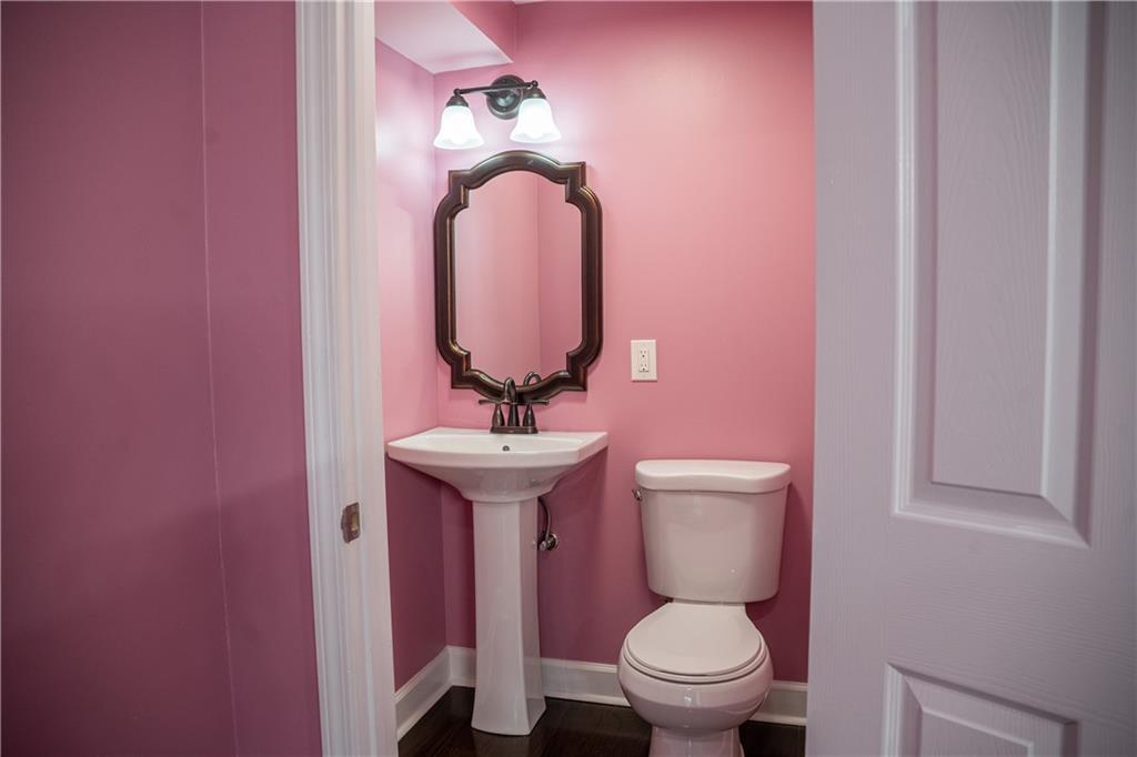 151 Cherokee Point Drive Canton, GA 30114 - Photo 163 of 163 a bathroom with a toilet a sink and mirror