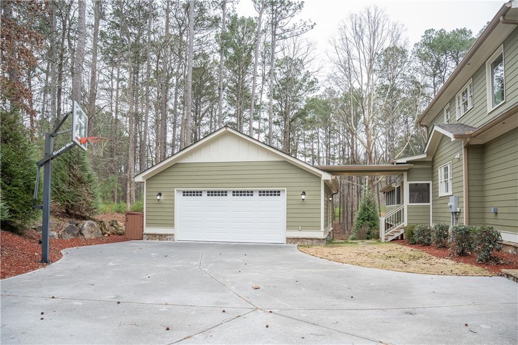 151 Cherokee Point Drive Canton, GA 30114 - Photo 18 of 163 a view of garage yard and tree