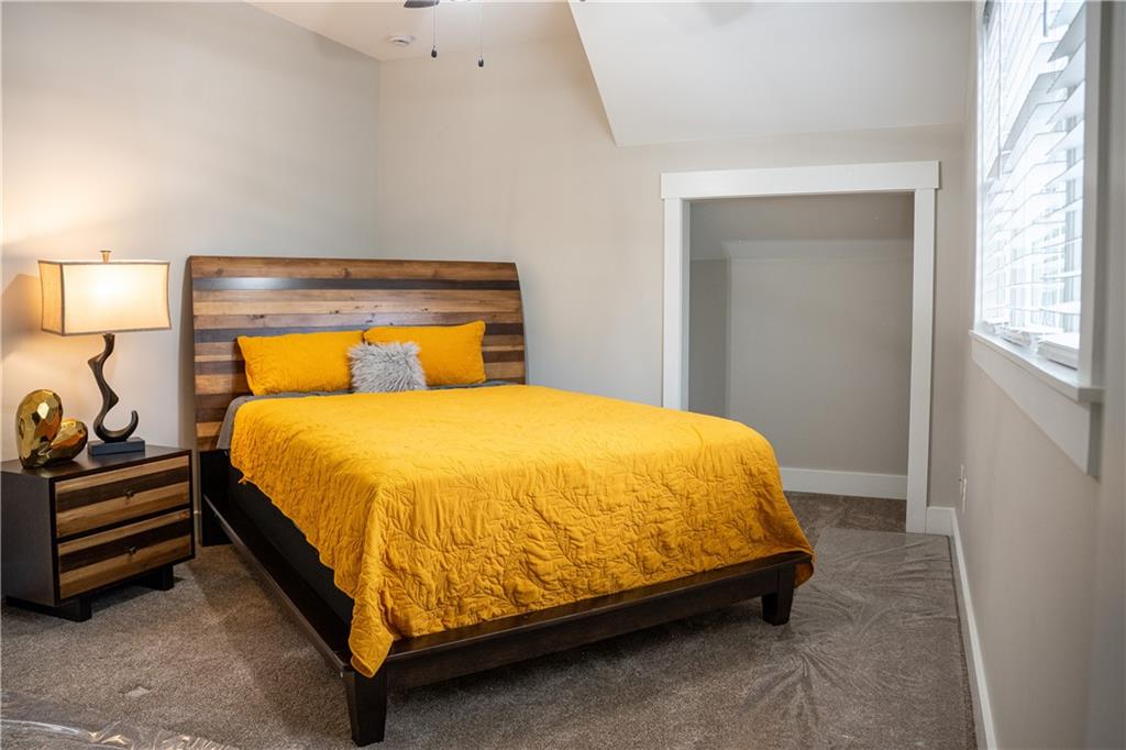 151 Cherokee Point Drive Canton, GA 30114 - Photo 51 of 163 a bed sitting in a bedroom next to a window