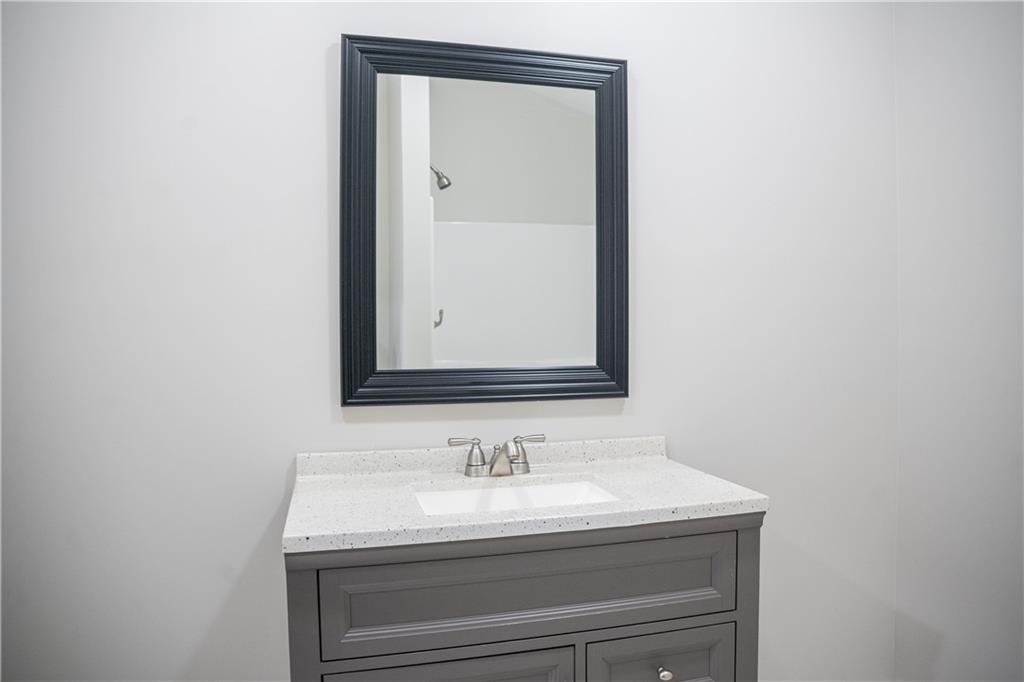 151 Cherokee Point Drive Canton, GA 30114 - Photo 65 of 163 a bathroom with a sink and a mirror
